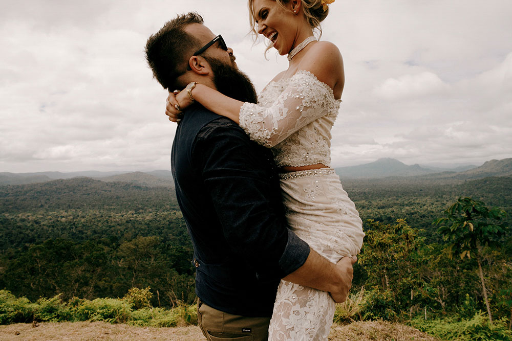 groom lifts bride at the top of the mountain in the jungle at this adventure belize wedding