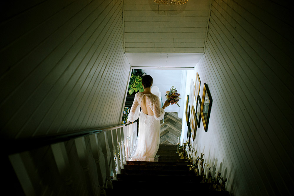 Bride walks down the stairs toward her wedding ceremony held in Muskoka ontario at the Northridge Inn Resort
