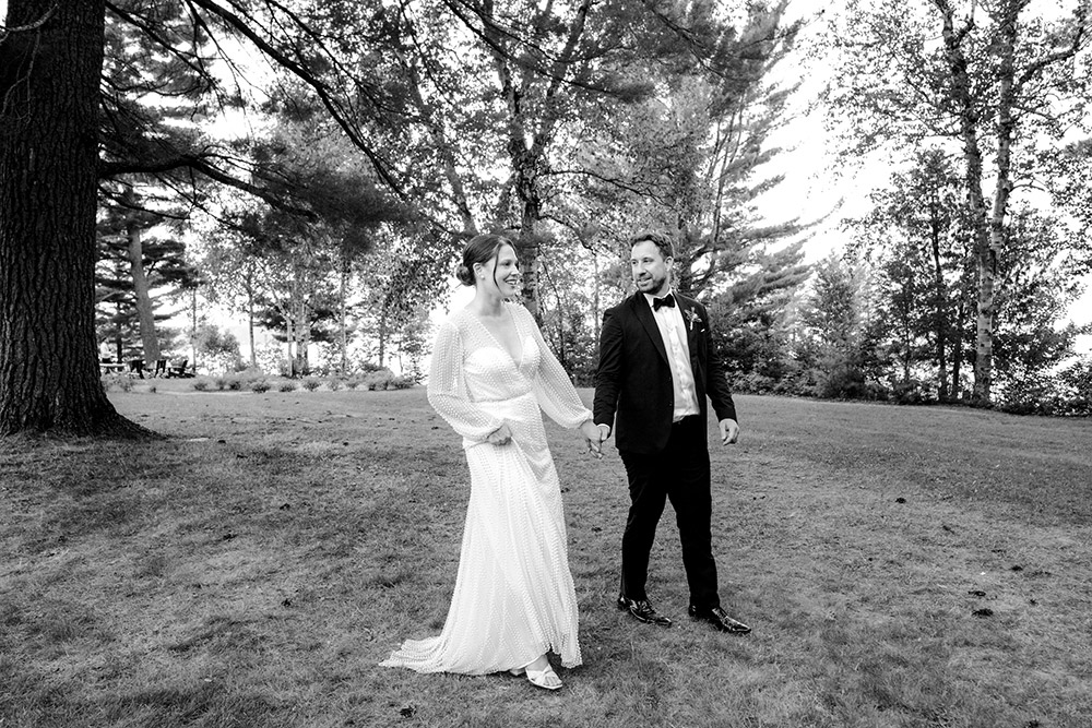 Bride and groom walk the grounds at their Northridge Inn Wedding in beautiful Muskoka