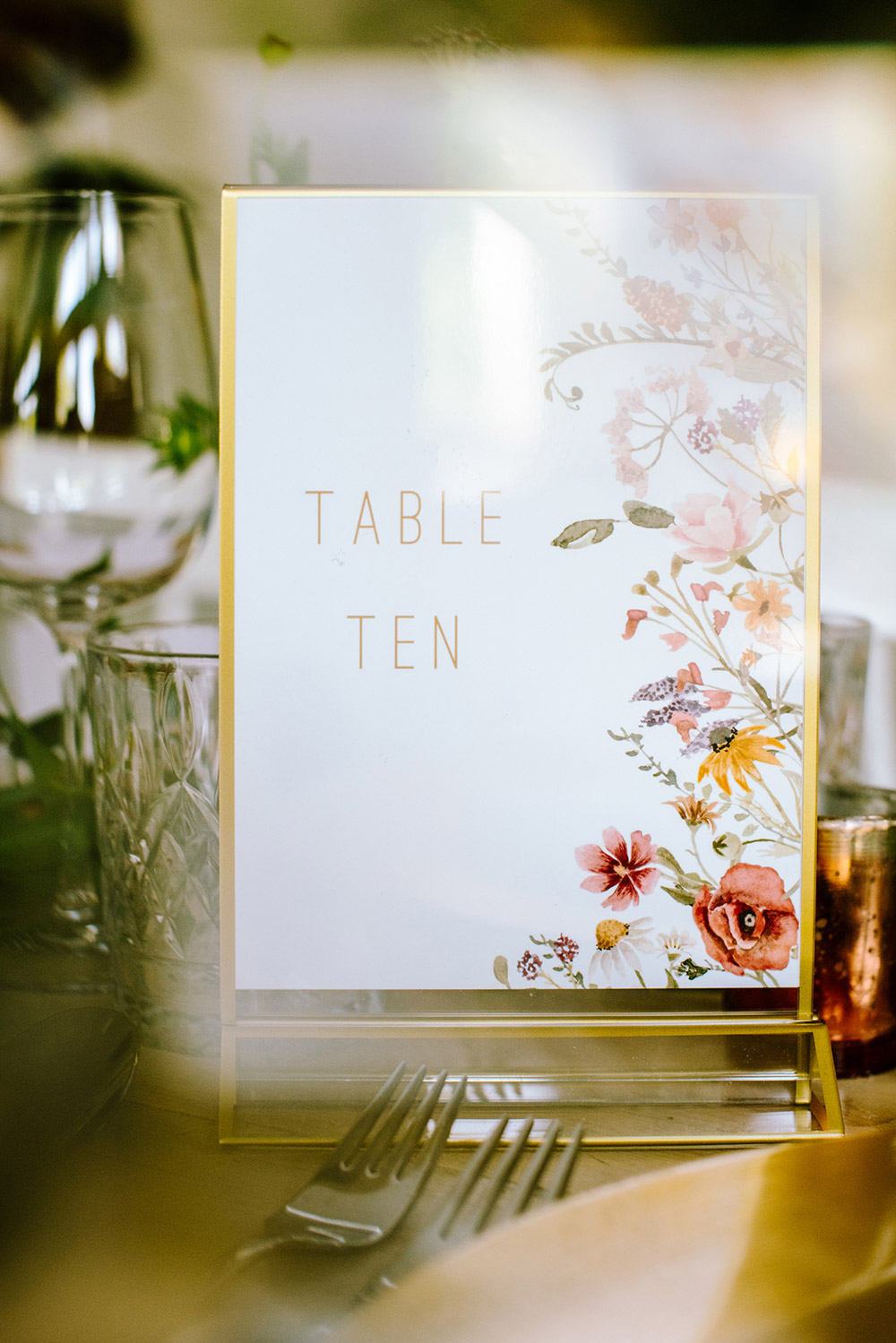 A sing reads TABLE TEN as part of the beautiful decor at this Northridge Inn Wedding in Muskoka Ontario