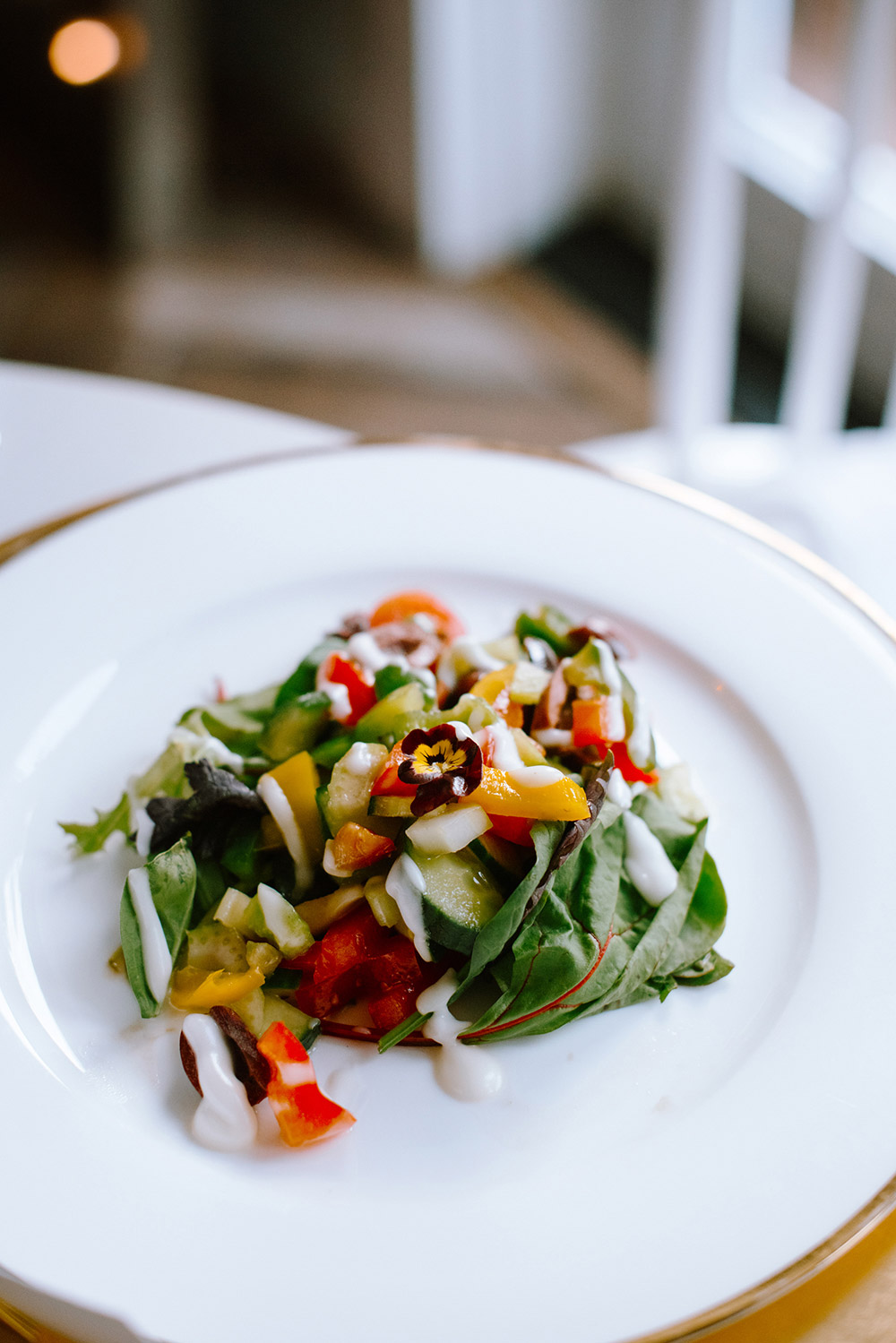 a beautifully plated salad topped with a flower at a Northridge Inn Wedding