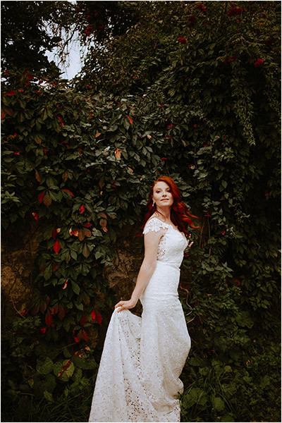 Elora Wedding photography of a beautiful bride posing within the foliage just outside the Elora Mill Hotel