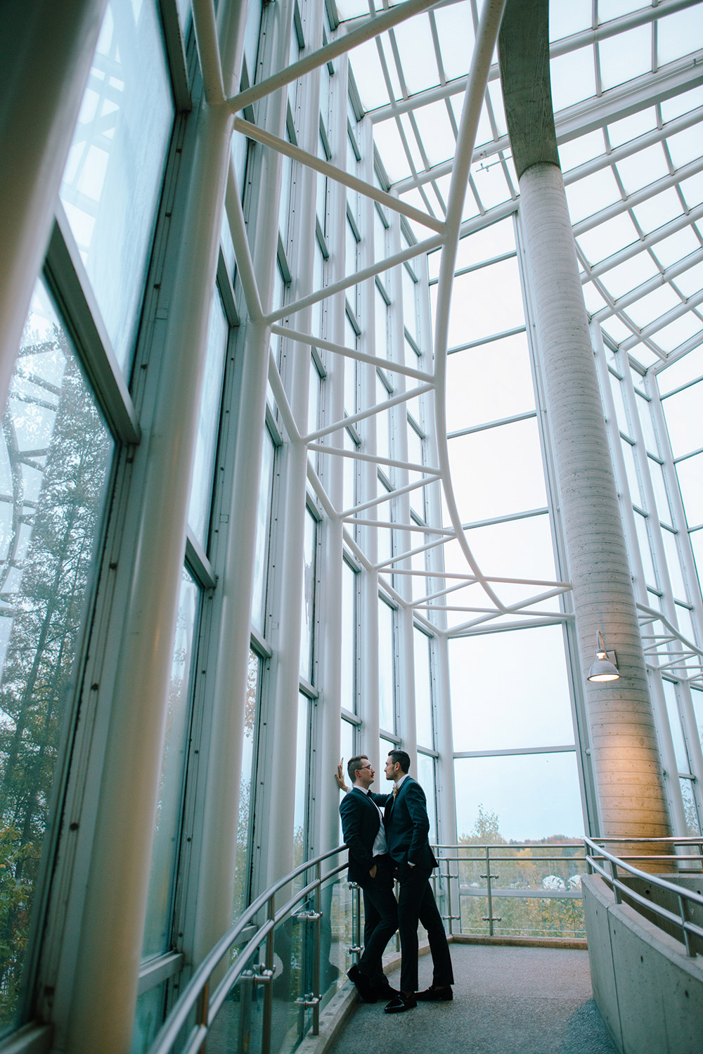 husbands pose on the windy staircase at this science north wedding