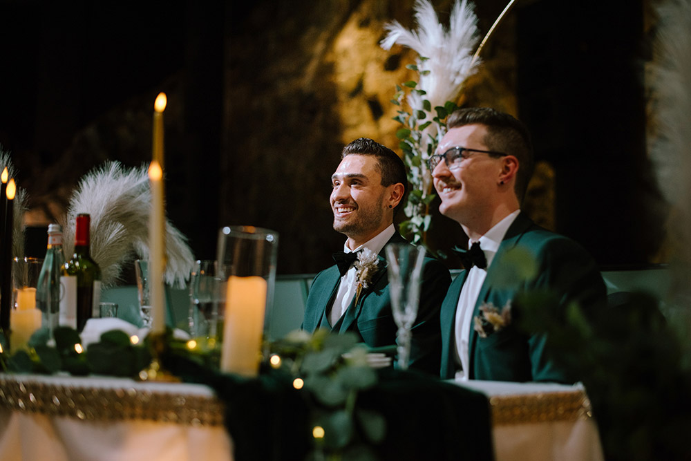 grooms enjoy the speeches from their head table at this this science north wedding