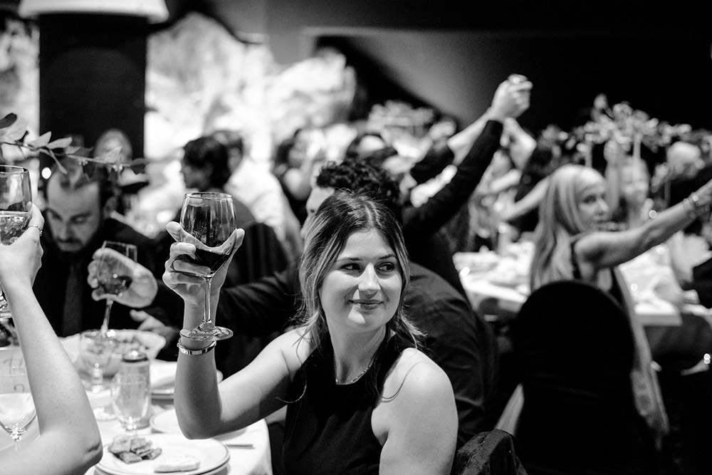 a women hols up her glass to cheers during a speech at this this science north wedding