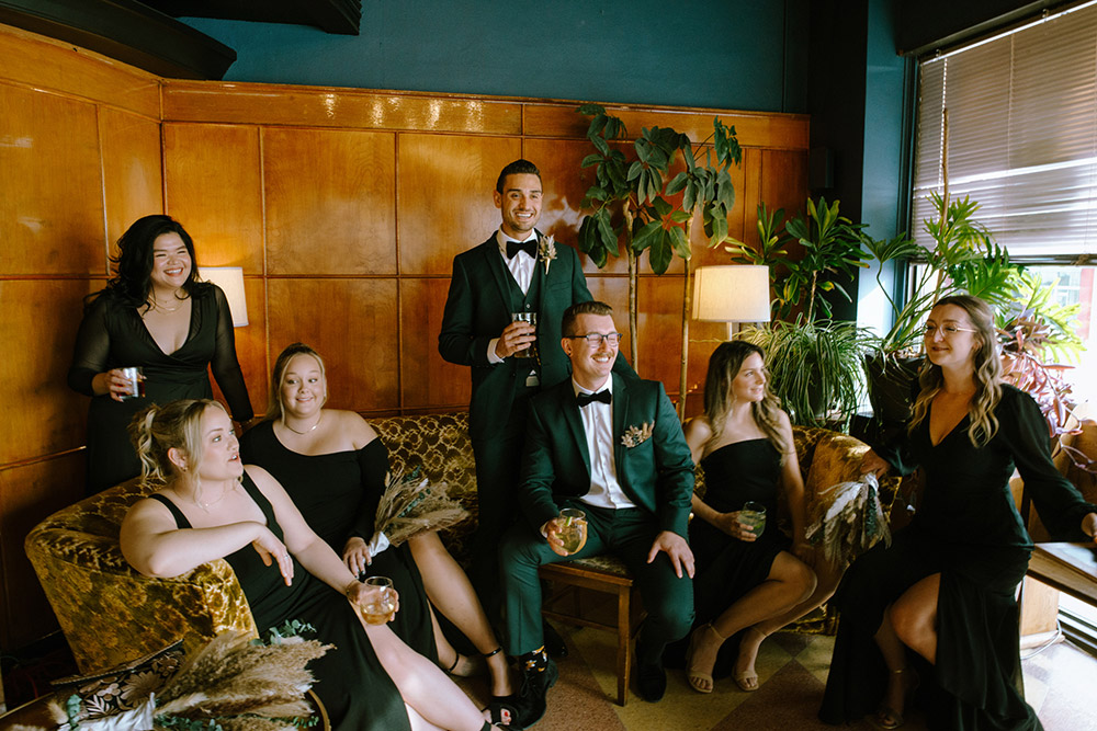 wedding party poses on vintage furniture at the knowhere public house at this science north wedding