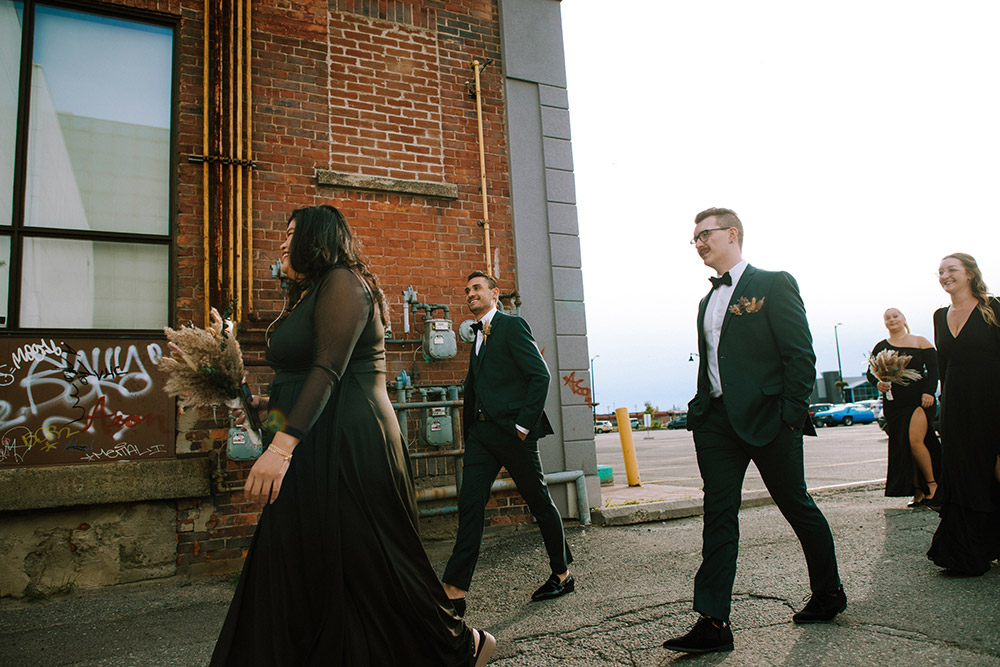 wedding party walk along the street to the science north wedding