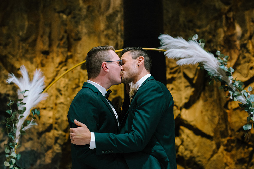 grooms kiss and seal their vows in the cavern at this science north wedding