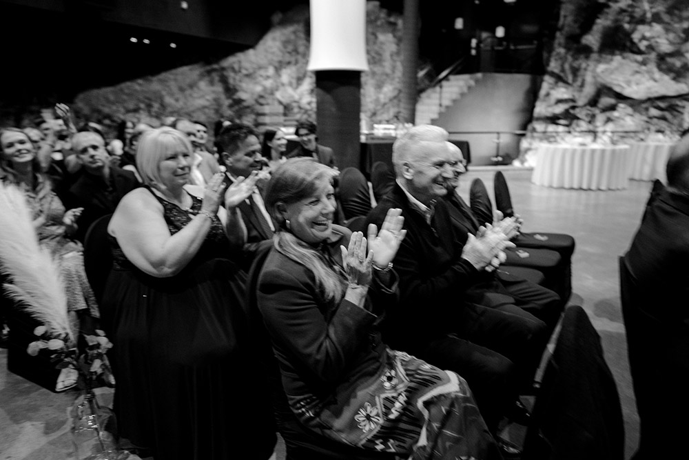 crowd applauds the moment the grooms seal their vows at this science north wedding