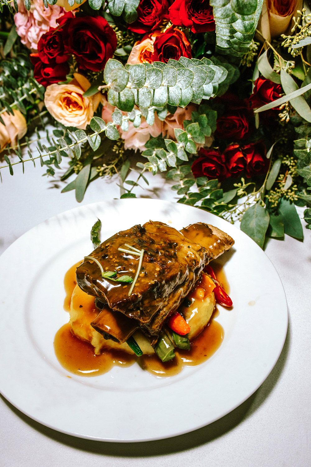 rib served over potato and vegetables and covered in gravy at The Doctor's House Wedding