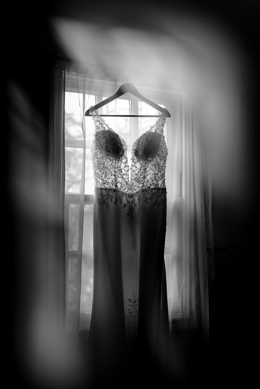 the wedding gown hangs in the window at The Doctor's House Wedding