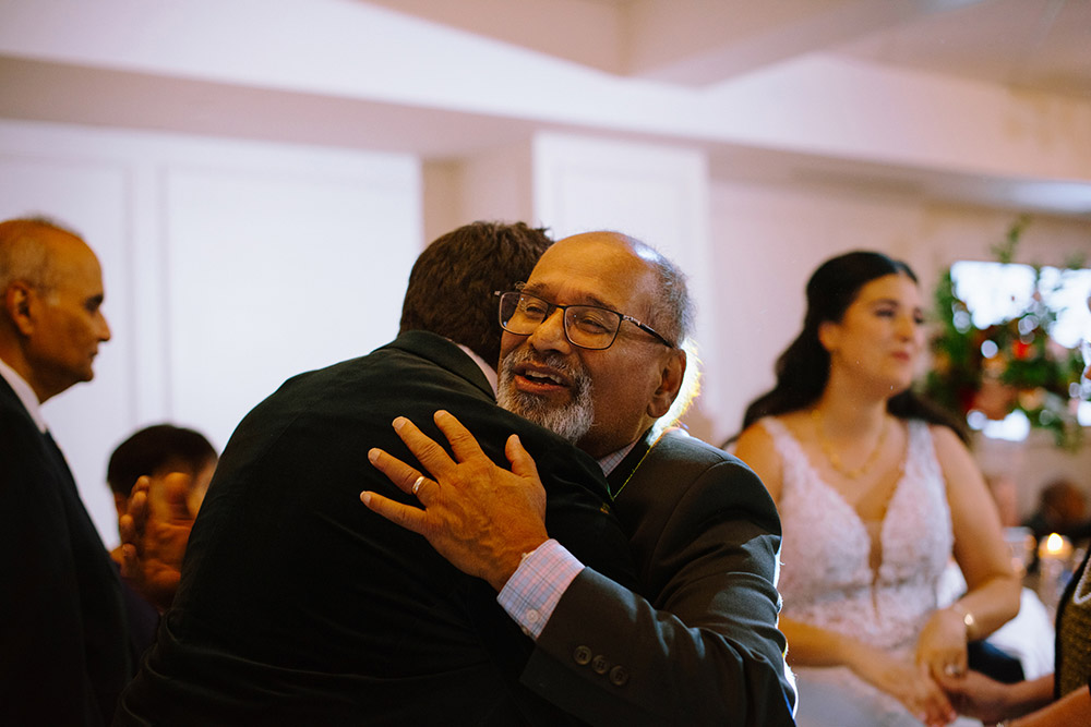 2 people embrace at The Doctor's House Wedding