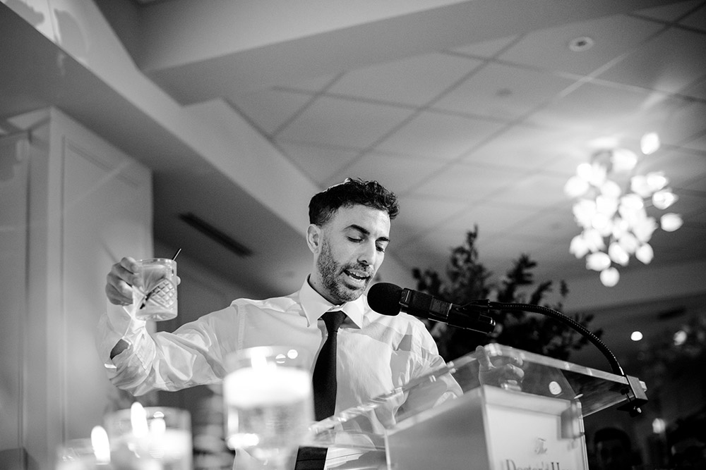 best man makesa toast and raises his glass at The Doctor's House Wedding