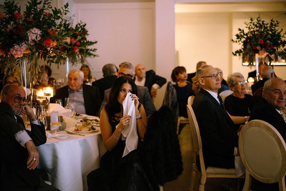 a guest wipes her tears during speecches at The Doctor's House Wedding
