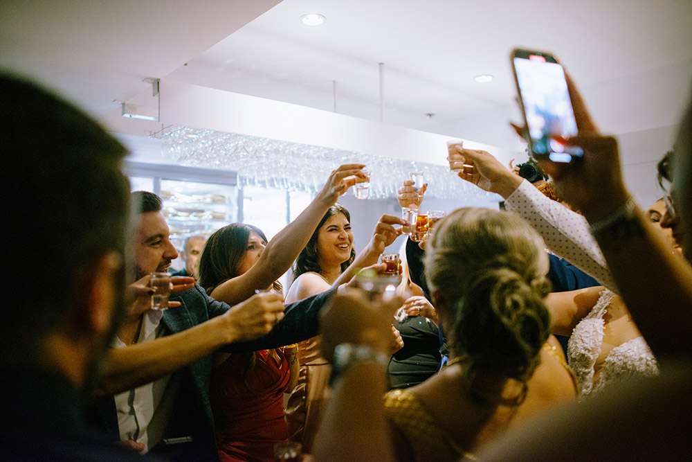 a group of guests cheers for a shot The Doctor's House Wedding
