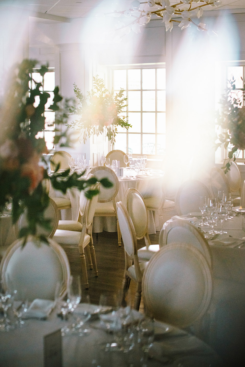 wedding reception detail shot featuring white chairs at The Doctor's House Wedding