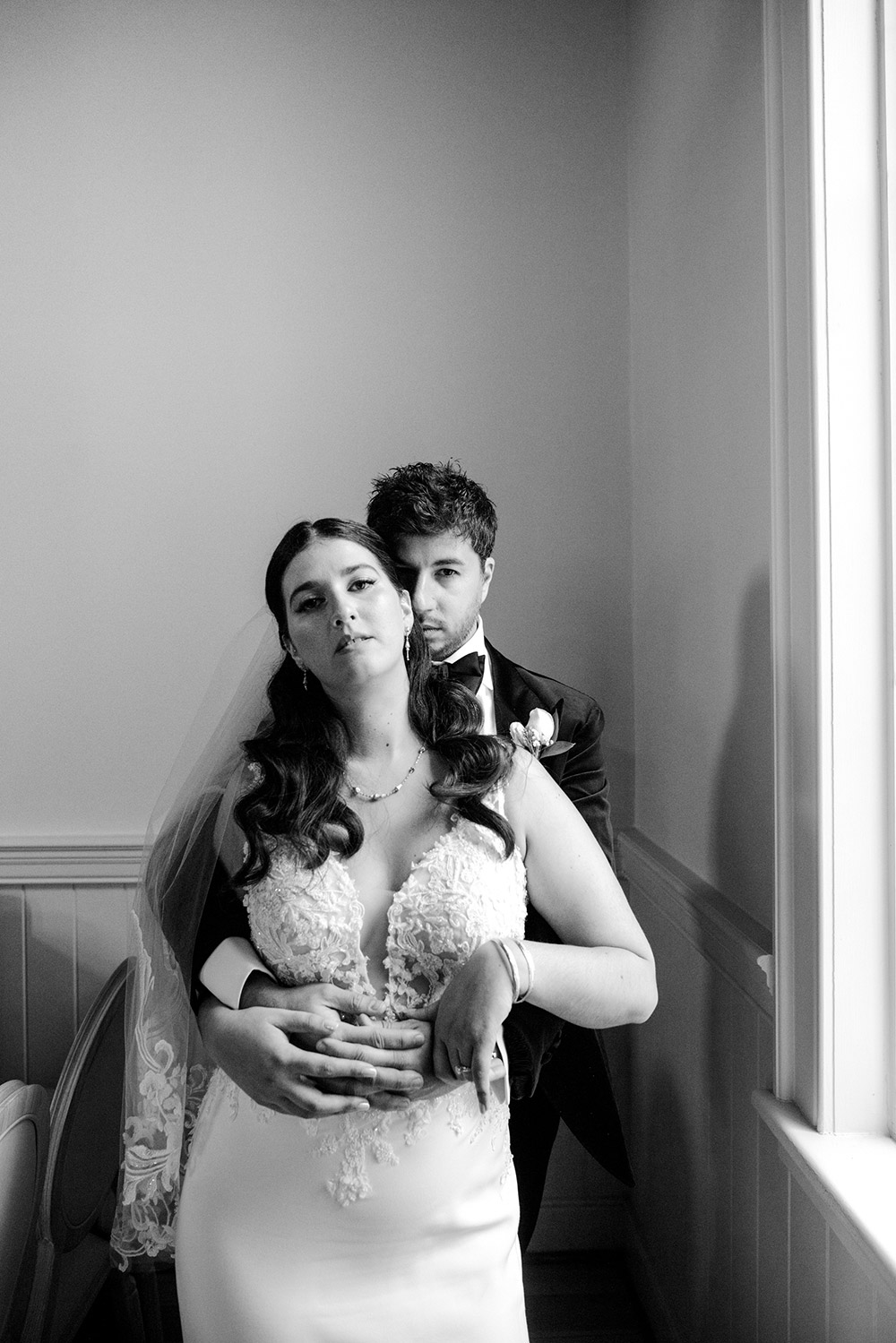 bride and groom pose by the window at The Doctor's House Wedding