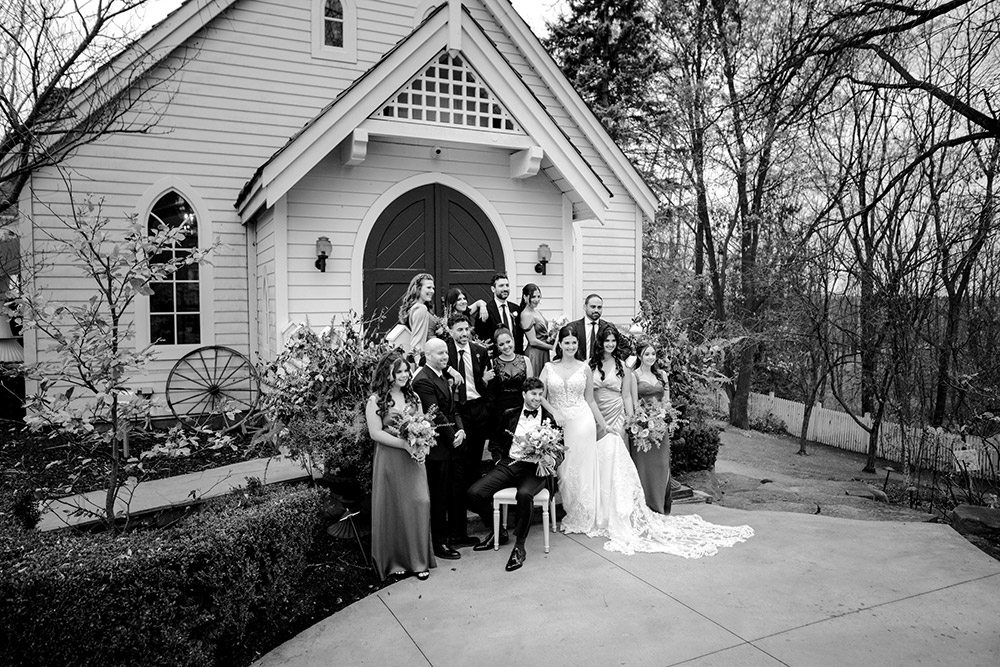 the wedding party pose in front of the chapel at The Doctor's House Wedding