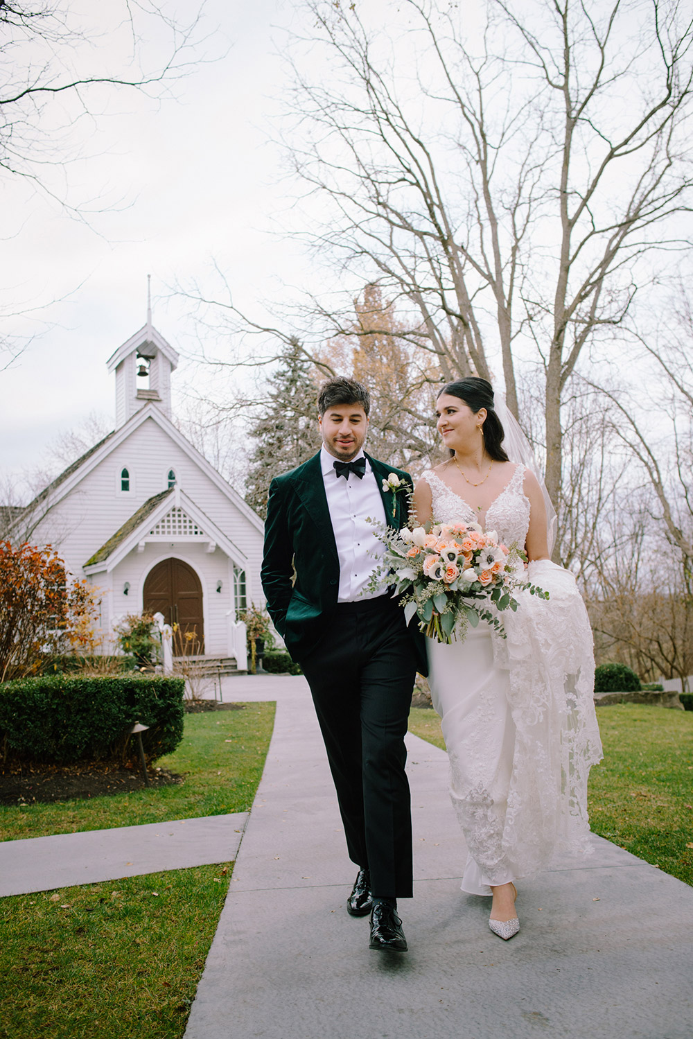 couple walk out from the chapel at The Doctor's House Wedding