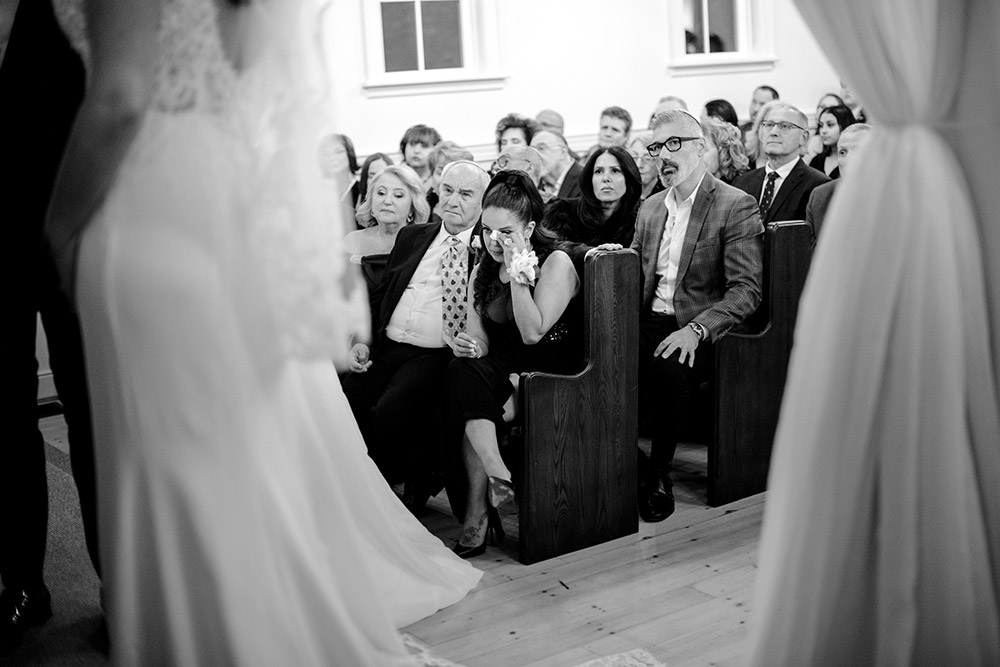 guest wipes her tear during the ceremony at The Doctor's House Wedding