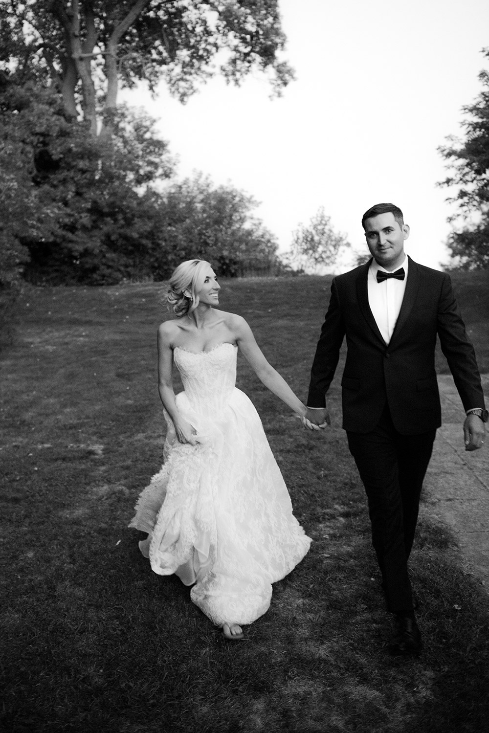 Bride and groom walk together during an evening portrait session this harding waterfront wedding